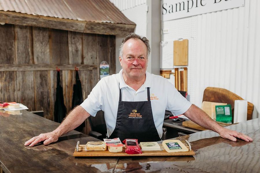 Tom Kennedy behind the sample bar at Anderson Cheese Stop